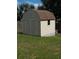 Backyard shed featuring a barn roof, double doors, trim, and latticework at 2509 Montecito Ave, Eustis, FL 32726