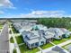 Birds-eye view of the neighborhood with colorful homes, lush landscaping and a beautiful treeline at 198 Gypsy Palace Ln, Daytona Beach, FL 32124