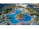 Aerial view of the community resort-style pool with tiki huts and lush landscaping at 198 Gypsy Palace Ln, Daytona Beach, FL 32124