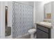 Functional bathroom with patterned shower curtain, vanity with granite countertop, and modern fixtures at 198 Gypsy Palace Ln, Daytona Beach, FL 32124