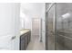 Bathroom featuring granite countertops, gray cabinetry, dual sinks, glass-door shower, and access to the closet at 198 Gypsy Palace Ln, Daytona Beach, FL 32124