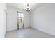 Bright bedroom features tiled floors, a modern chandelier, and large window with decorative curtains at 198 Gypsy Palace Ln, Daytona Beach, FL 32124
