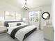 Bedroom featuring gray accents, bright walls, decorative wall art, a queen-sized bed, and a sun-lit window at 198 Gypsy Palace Ln, Daytona Beach, FL 32124