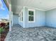 View of the open-air carport featuring stone pavers and a view of the neighborhood street at 198 Gypsy Palace Ln, Daytona Beach, FL 32124