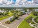 Community entrance showcasing tropical landscaping, palm trees and shopping at 198 Gypsy Palace Ln, Daytona Beach, FL 32124