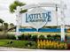 Close-up of the Latitude Margaritaville community sign with lush landscaping at 198 Gypsy Palace Ln, Daytona Beach, FL 32124