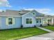 Exterior elevation of a charming two-story home with a landscaped yard and covered front porch at 198 Gypsy Palace Ln, Daytona Beach, FL 32124