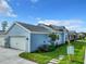 Charming blue home with a well-maintained lawn, paved walkway, and attached garage at 198 Gypsy Palace Ln, Daytona Beach, FL 32124