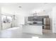 Open concept kitchen with stainless steel appliances, gray cabinetry, and a center island with granite countertop at 198 Gypsy Palace Ln, Daytona Beach, FL 32124