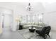 Inviting living room featuring modern furniture, ample natural light, and an elegant chandelier at 198 Gypsy Palace Ln, Daytona Beach, FL 32124