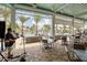 Inviting outdoor seating area with tables and chairs near the pool with swaying palm trees in view at 198 Gypsy Palace Ln, Daytona Beach, FL 32124