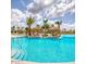 Resort-style pool featuring tiki huts, lush landscaping, and crystal-clear water at 198 Gypsy Palace Ln, Daytona Beach, FL 32124