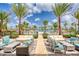 Relaxing pool area with palm trees, comfortable seating, and clear blue skies on a sunny day at 198 Gypsy Palace Ln, Daytona Beach, FL 32124