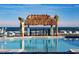 Beautiful pool with tiki hut, palm trees, beach access and several lounge chairs for relaxing at 198 Gypsy Palace Ln, Daytona Beach, FL 32124