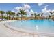 Large pool featuring clear blue water, fountains, and palm trees creating a tropical paradise at 198 Gypsy Palace Ln, Daytona Beach, FL 32124