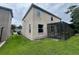 Backyard view featuring a screened-in patio and a well-maintained lawn at 606 Carrigan Woods Trl, Oviedo, FL 32765