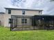 Backyard view featuring a screened-in patio and a well-maintained lawn at 606 Carrigan Woods Trl, Oviedo, FL 32765