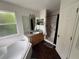 Bathroom with a bathtub, sink, marble lined shower, and dark wood floor at 606 Carrigan Woods Trl, Oviedo, FL 32765