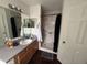 Bathroom with a sink, mirror and a marble lined shower stall at 606 Carrigan Woods Trl, Oviedo, FL 32765