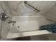 Close-up of a white bathtub with marbled surround and chrome fixtures at 606 Carrigan Woods Trl, Oviedo, FL 32765