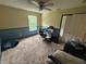 Bedroom with yellow and blue walls, brown carpet and a ceiling fan and a window at 606 Carrigan Woods Trl, Oviedo, FL 32765