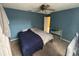 Bedroom with blue walls, ceiling fan, and carpet providing a calm interior space at 606 Carrigan Woods Trl, Oviedo, FL 32765