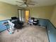 Bedroom with yellow and blue walls, brown carpet and a ceiling fan at 606 Carrigan Woods Trl, Oviedo, FL 32765