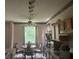 A dining area with a ceiling fan, a window, and a round table with chairs at 606 Carrigan Woods Trl, Oviedo, FL 32765