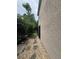 Exterior view of the house with a landscaped side yard with gravel and stepping stones at 606 Carrigan Woods Trl, Oviedo, FL 32765
