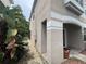 Exterior view of the house with tropical landscaping and stone path to entrance at 606 Carrigan Woods Trl, Oviedo, FL 32765