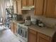 A kitchen with wooden cabinets, a white oven, and a beige countertop at 606 Carrigan Woods Trl, Oviedo, FL 32765
