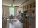 A kitchen with tile floors, wooden cabinets, an oven and a dining area at 606 Carrigan Woods Trl, Oviedo, FL 32765