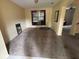 Open living room with neutral walls, large window and adjacent staircase at 606 Carrigan Woods Trl, Oviedo, FL 32765