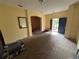 Open living room with neutral carpet, an arched doorway, and open entrance at 606 Carrigan Woods Trl, Oviedo, FL 32765