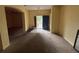 Open living room with neutral carpet, an arched doorway, and open entrance at 606 Carrigan Woods Trl, Oviedo, FL 32765