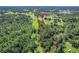 Aerial view showcasing property boundaries, wooded areas, and surrounding landscape at 10222 Rockridge Rd, Lakeland, FL 33810