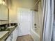 Bathroom featuring double sinks with black countertop and a shower with curtain at 10222 Rockridge Rd, Lakeland, FL 33810