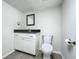 Well-lit half bathroom featuring modern fixtures, a sleek vanity, and a toilet at 10222 Rockridge Rd, Lakeland, FL 33810