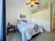 Comfortable bedroom with soft carpet, a full sized bed and a ceiling fan at 10222 Rockridge Rd, Lakeland, FL 33810