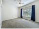 Bright bedroom with plush carpet, large window, and ample natural light at 10222 Rockridge Rd, Lakeland, FL 33810