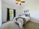 Cozy bedroom featuring a comfy bed, a window and plush carpet at 10222 Rockridge Rd, Lakeland, FL 33810