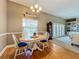 Charming dining area with hardwood flooring, classic chandelier and large window providing ample light at 10222 Rockridge Rd, Lakeland, FL 33810