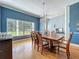 Bright dining room showcasing a large window, hardwood floors, and elegant decor at 10222 Rockridge Rd, Lakeland, FL 33810