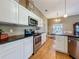 Bright kitchen featuring stainless steel appliances, ample white cabinetry, and wood flooring with a breakfast nook at 10222 Rockridge Rd, Lakeland, FL 33810