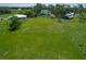 Expansive vacant land with lush greenery and distant houses at 10222 Rockridge Rd, Lakeland, FL 33810