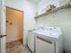 Bright laundry room with modern washer and dryer units and ample storage space at 10222 Rockridge Rd, Lakeland, FL 33810