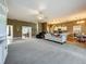 Open-concept living area with carpet, seamlessly connecting to kitchen and dining at 10222 Rockridge Rd, Lakeland, FL 33810