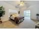 Spacious main bedroom with carpet, ceiling fan, and ample natural light at 10222 Rockridge Rd, Lakeland, FL 33810