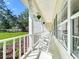 Relaxing front porch with white rocking chairs and scenic views at 10222 Rockridge Rd, Lakeland, FL 33810