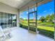 Relaxing screened porch overlooking a lush green yard and blue skies at 10222 Rockridge Rd, Lakeland, FL 33810